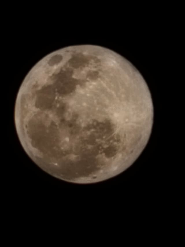 A full moon against a black night sky