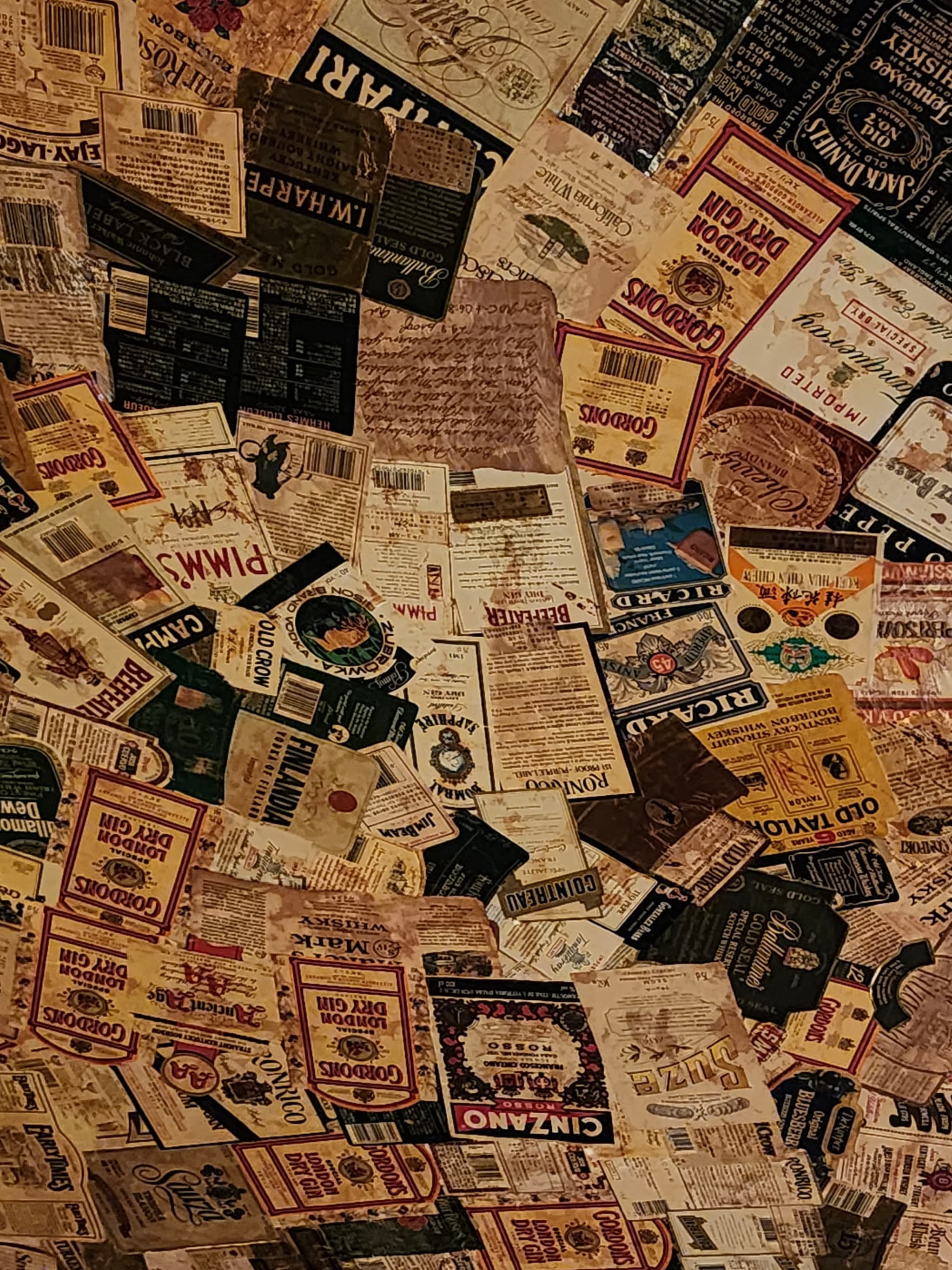 A collage of various vintage posters, advertisements, and labels in different colors and designs, overlapping each other